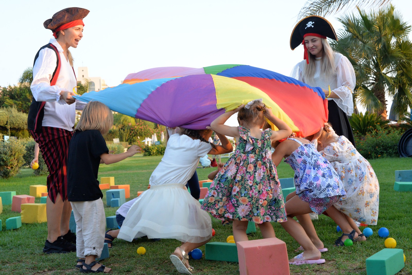 a group of children playing with a large parachute