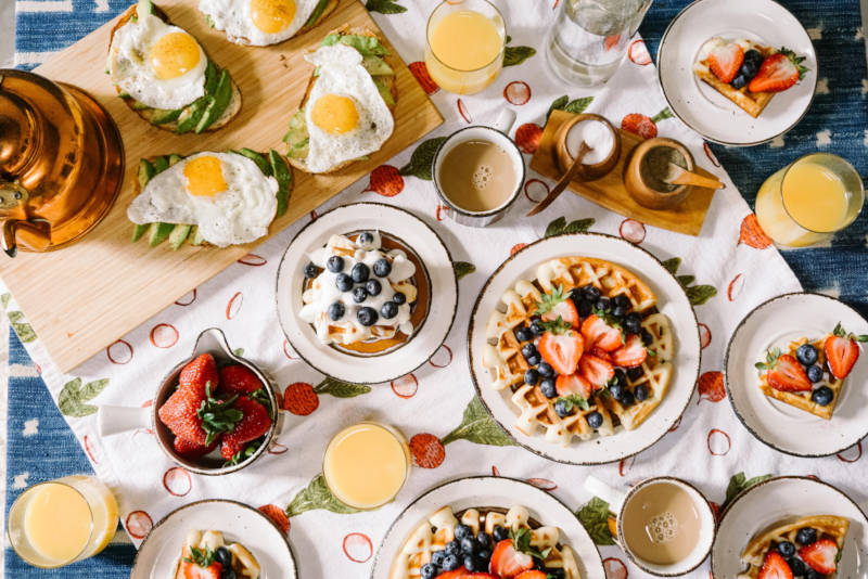 a table with plates of food and drinks