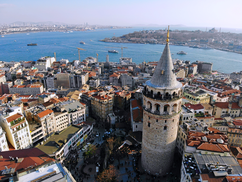 a city with a tower and water in the background