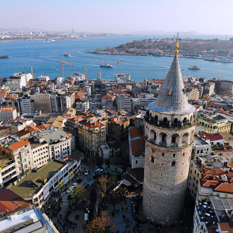 a city with a tower and water in the background