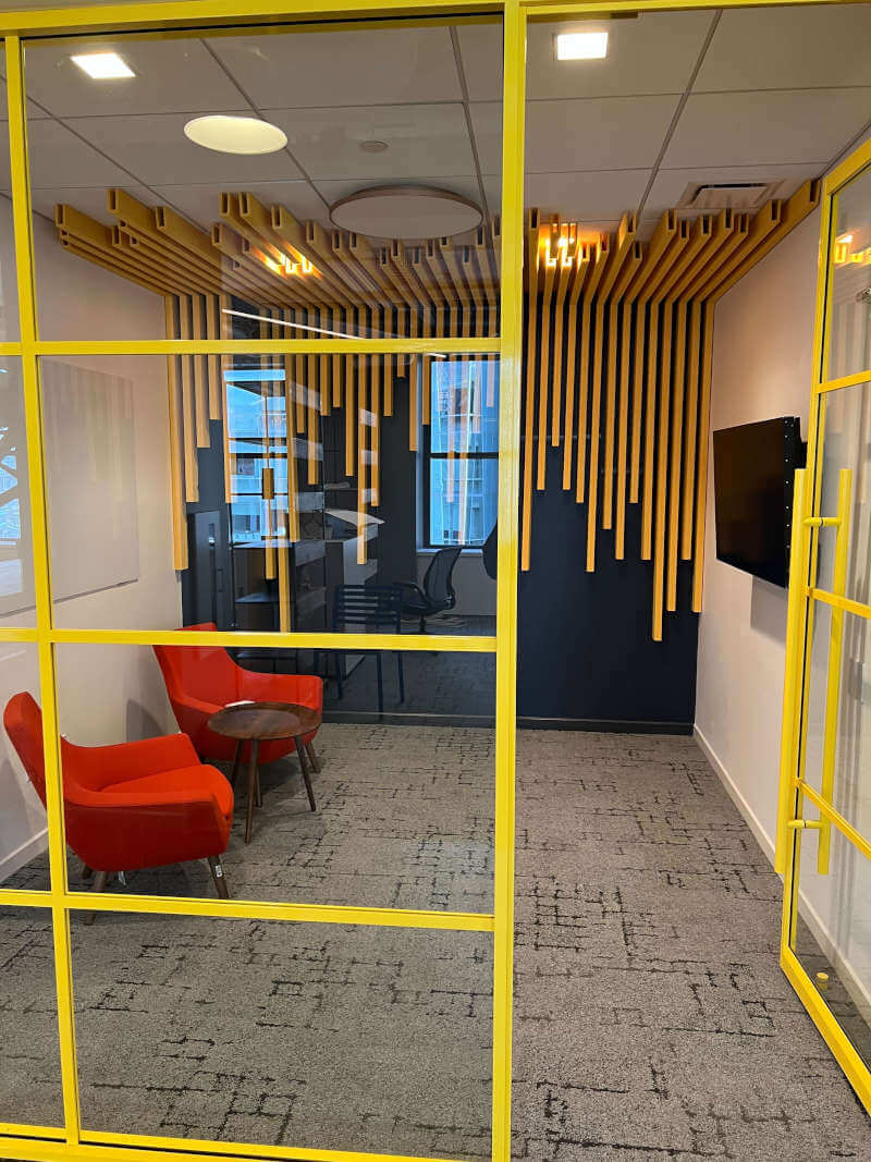 a room with yellow glass walls and a yellow wall