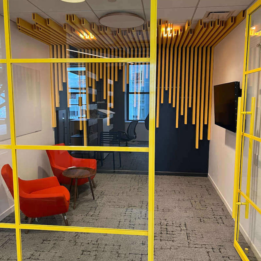 a room with yellow glass walls and a yellow wall