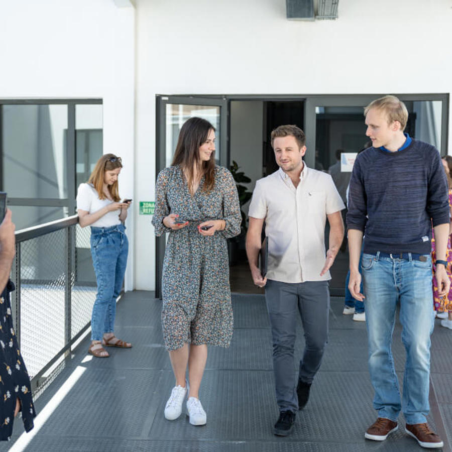 a group of people walking on a walkway