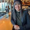 a woman sitting at a bar