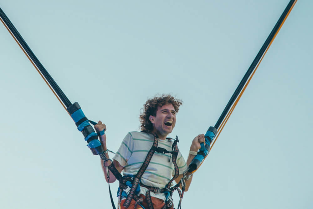a man jumping in a bungee jumping