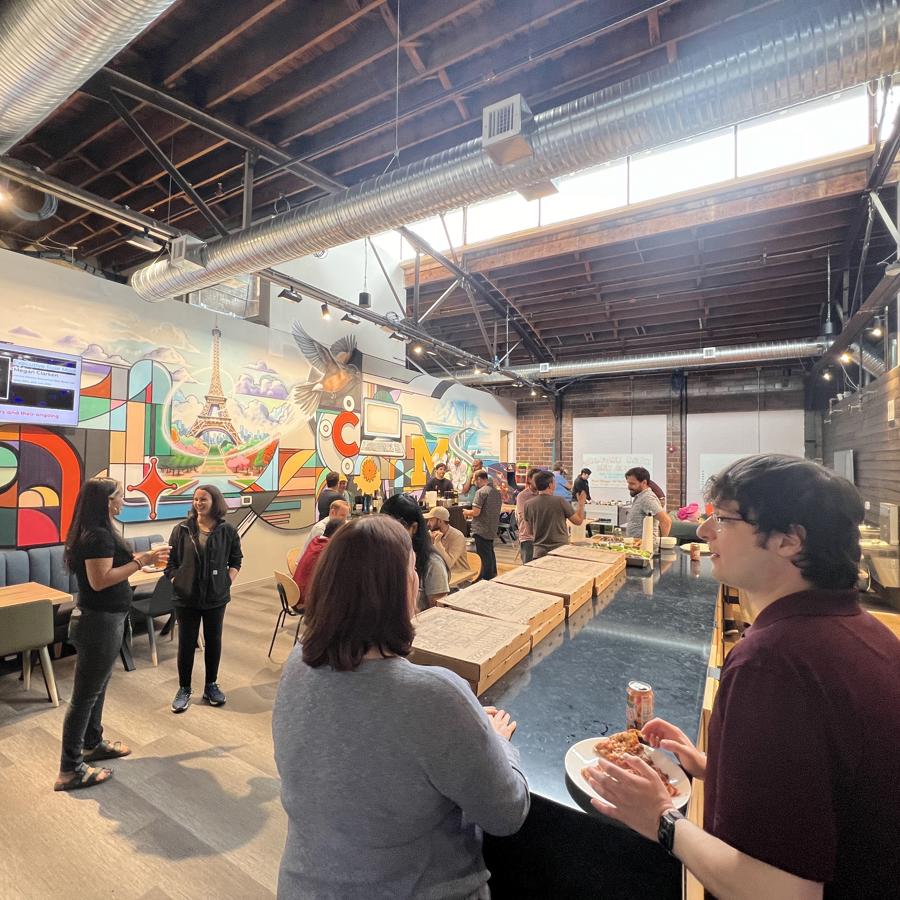 a group of people in a room with a large wall and a large ceiling