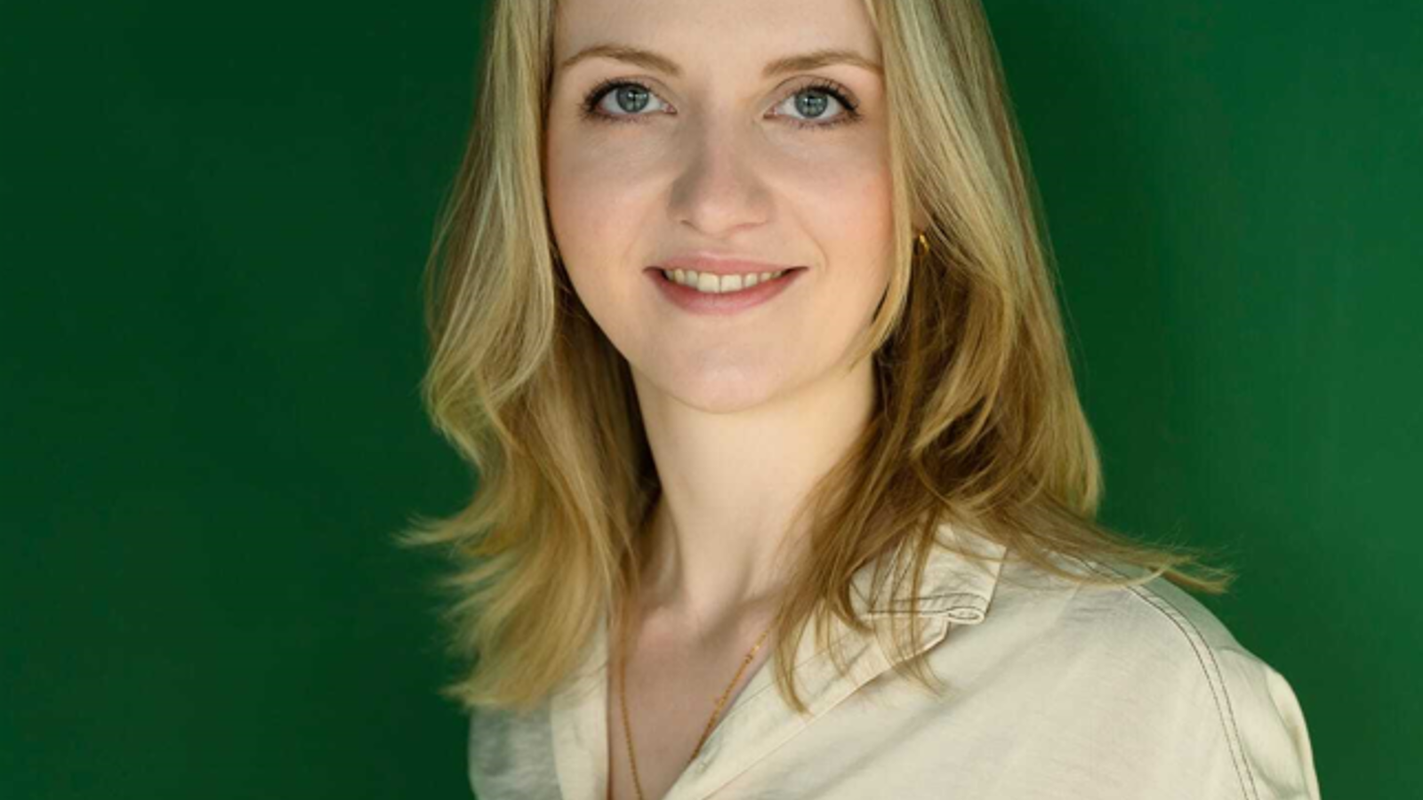 a woman with blonde hair smiling