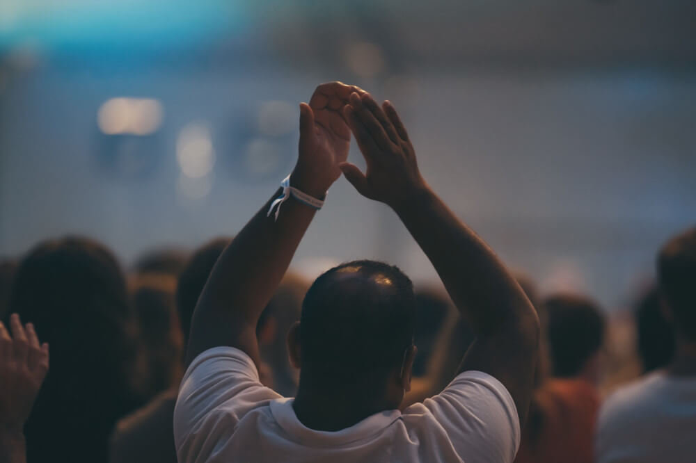 a man raising his hands up