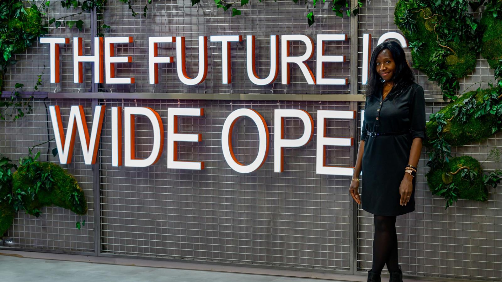 a woman standing in front of a sign