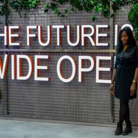 a woman standing in front of a sign