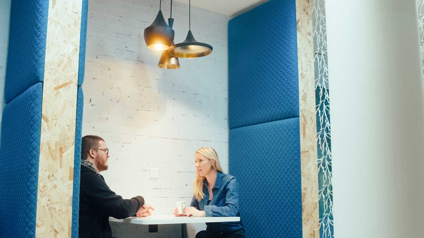 a man and woman sitting at a table