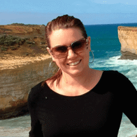 a woman standing in front of a cliff
