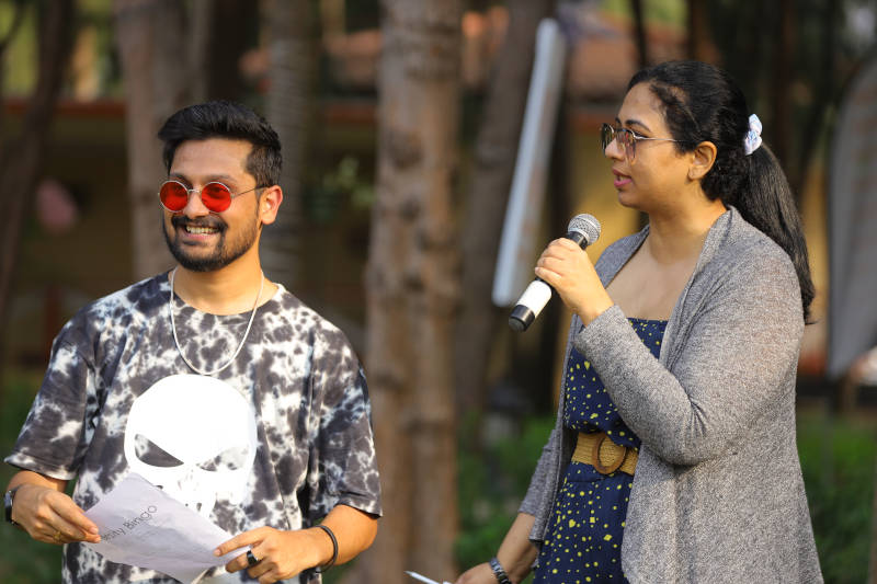 a man and woman standing outside holding a microphone