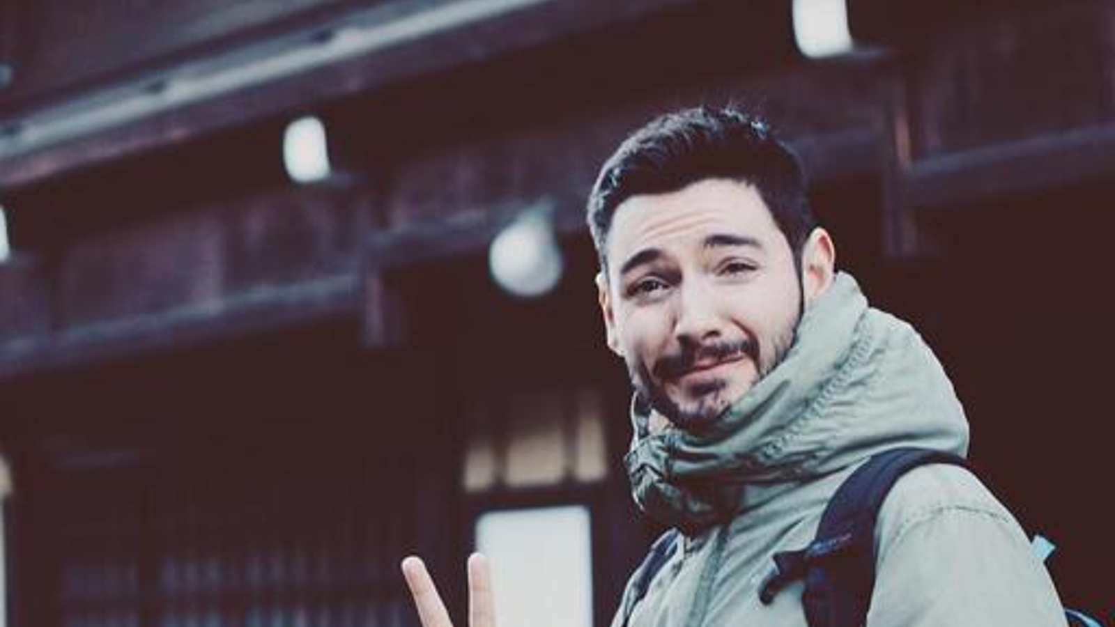a man with a backpack and a peace sign