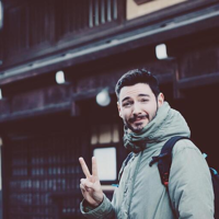 a man with a backpack and a peace sign