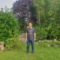 a man standing in a grassy area