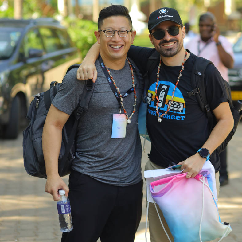 two men standing on a sidewalk