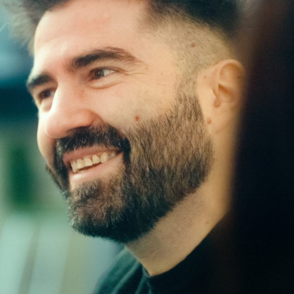 a man with a beard smiling