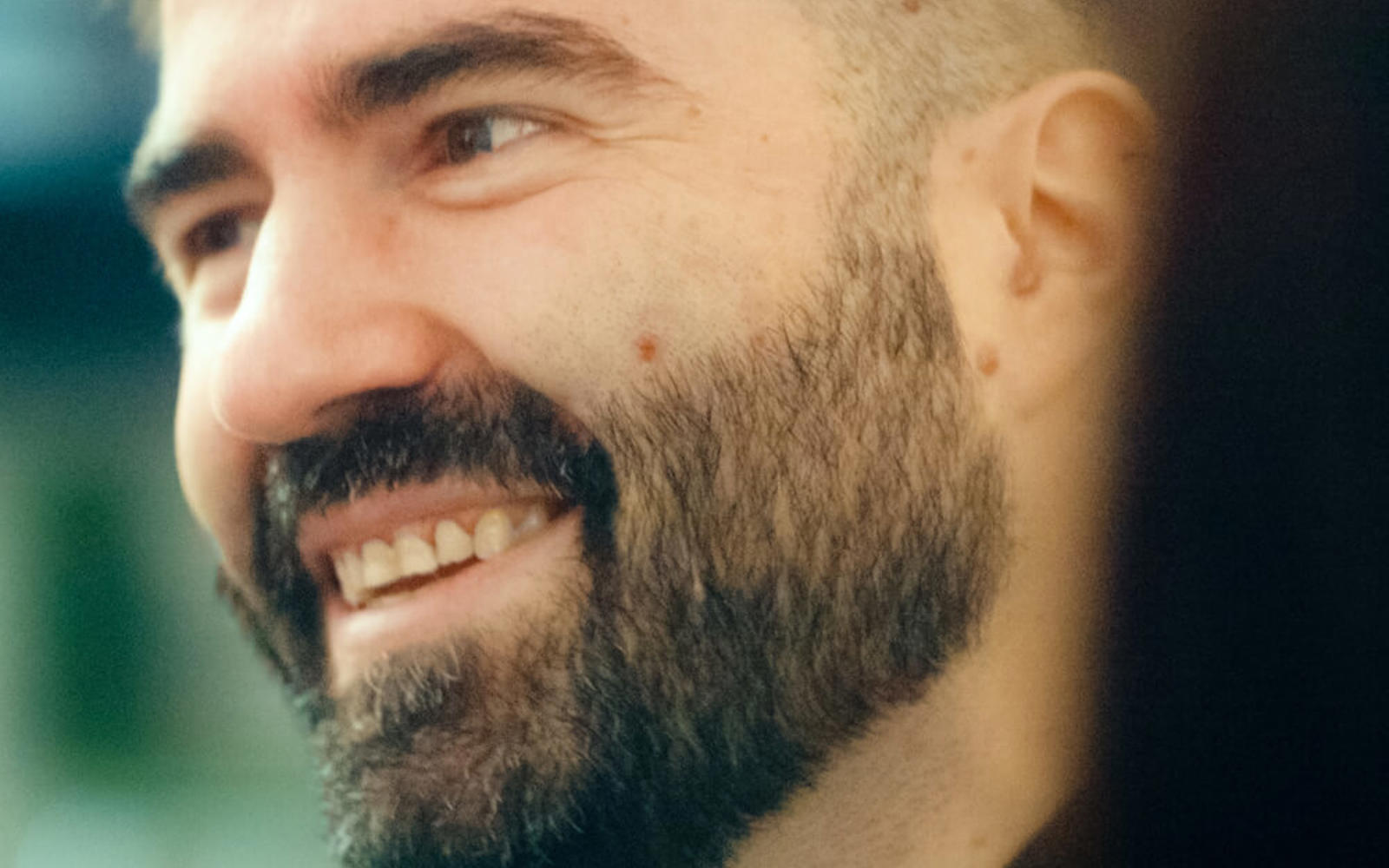 a man with a beard smiling