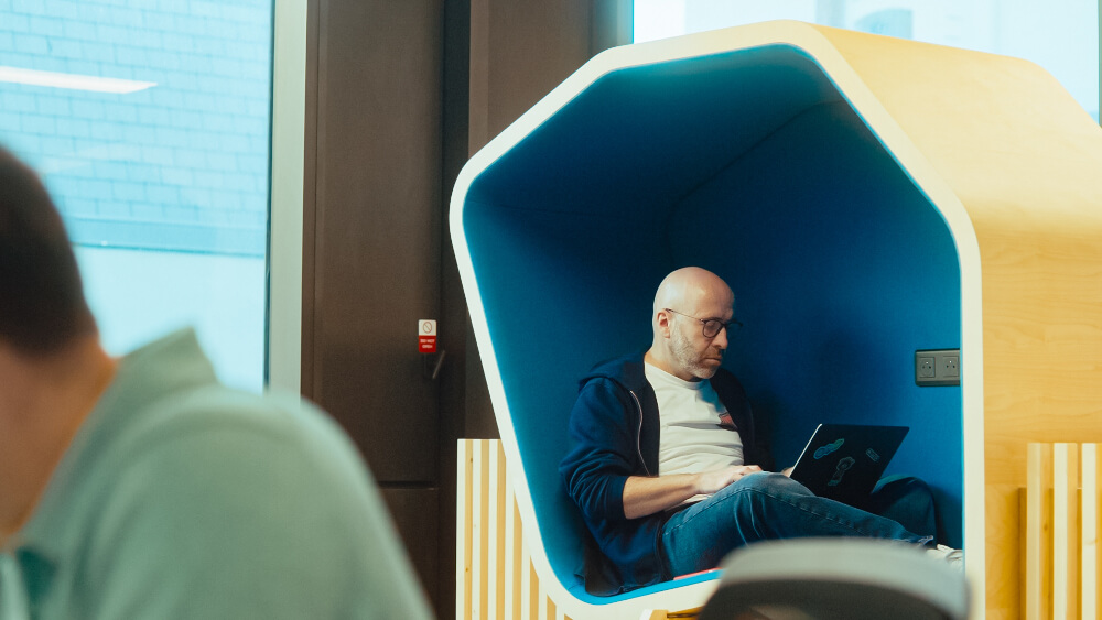 a man sitting in a chair with a laptop