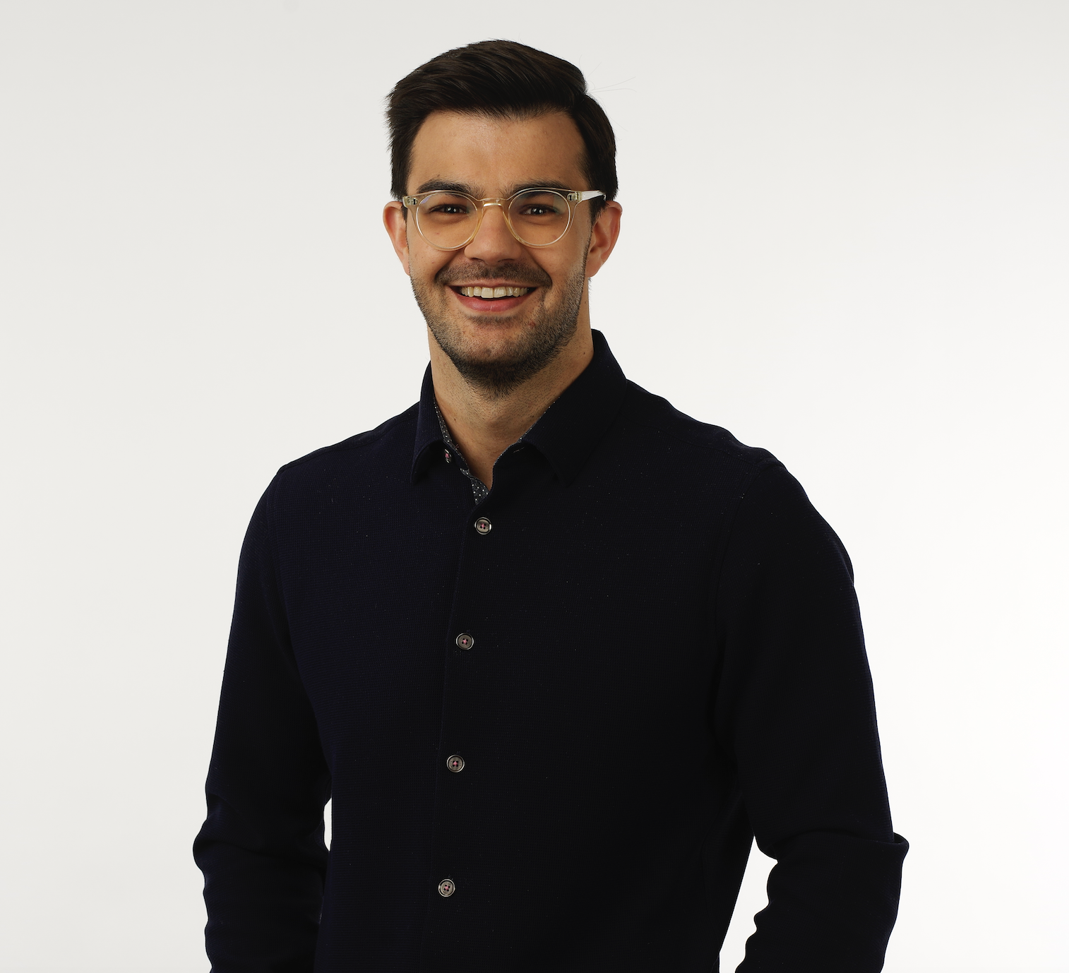 a man wearing glasses and smiling