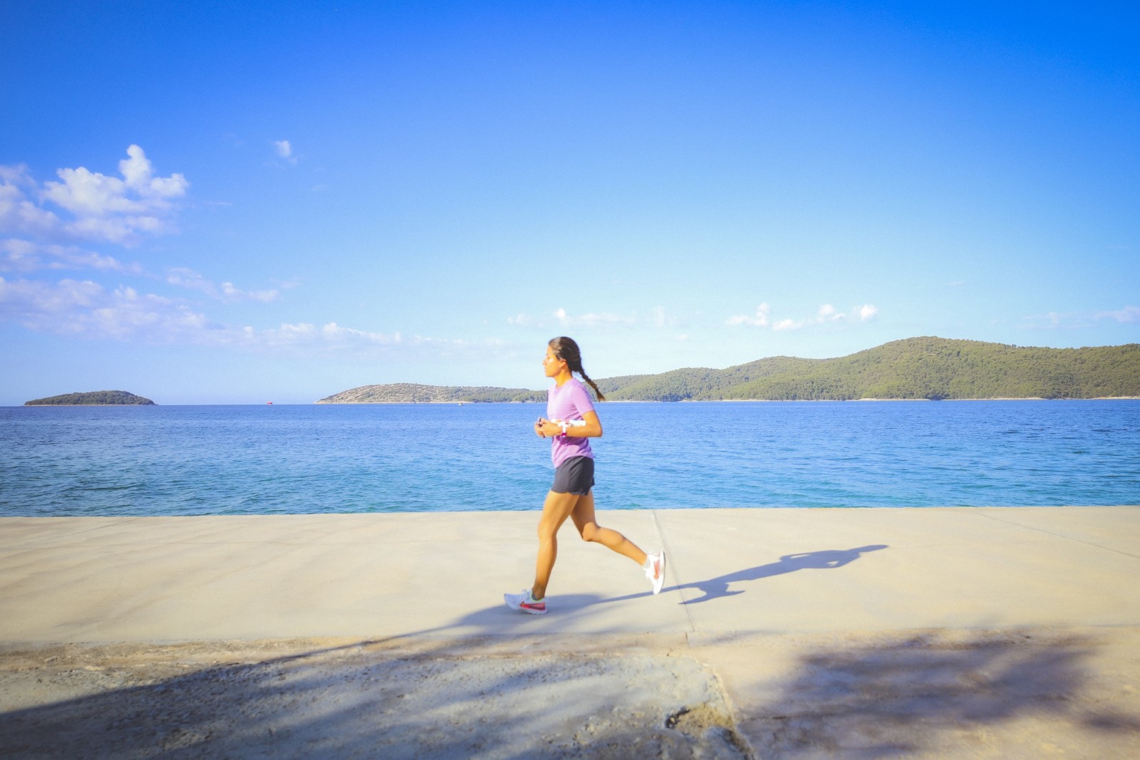 a woman running near water