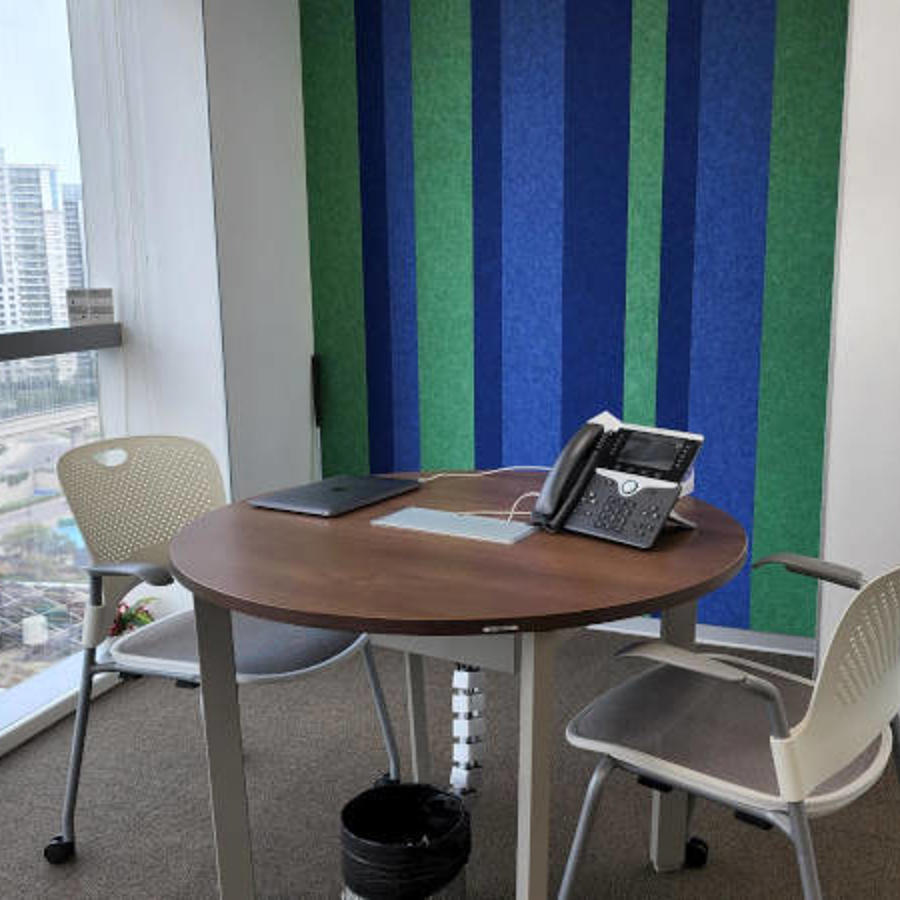 a table with chairs and a laptop