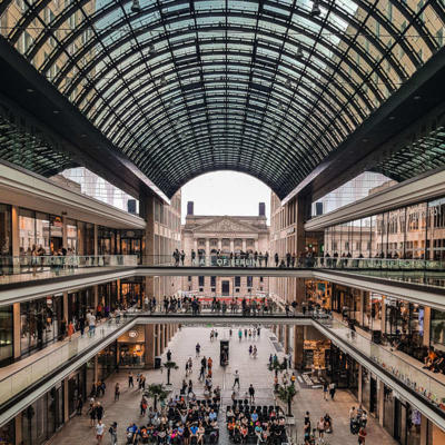 a large glass building with many people