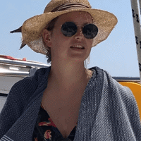 a woman wearing a hat and sunglasses