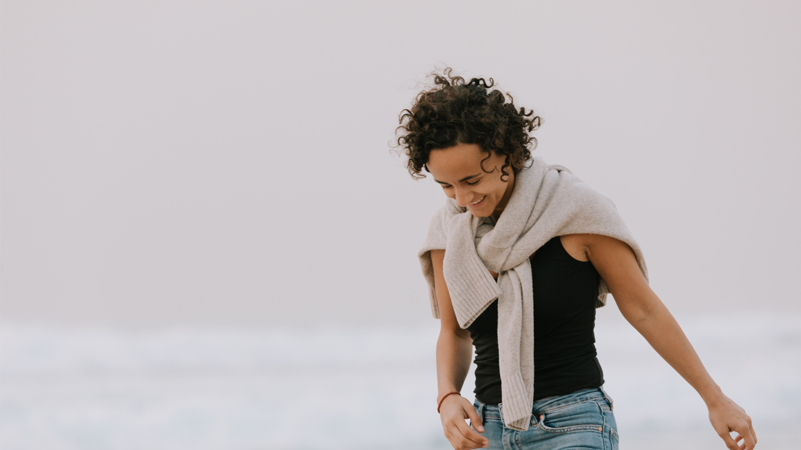 a woman wearing a scarf and black shirt
