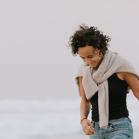 a woman wearing a scarf and black shirt