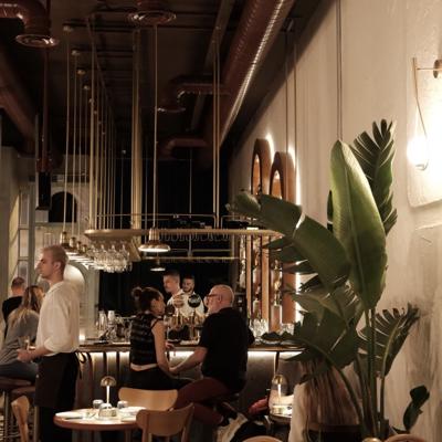 a group of people sitting at tables in a restaurant