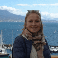 a woman standing next to a city