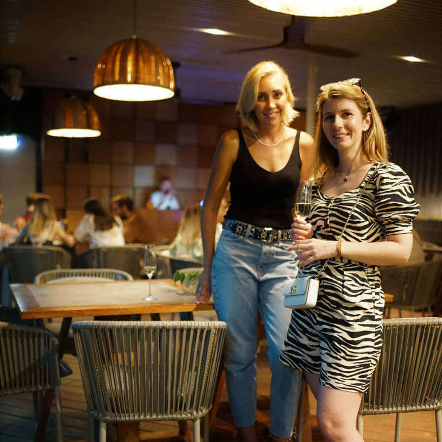 two women standing in a restaurant