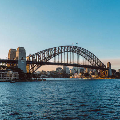 Sydney Harbour Bridge over water with buildings in the background