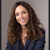a woman with long curly hair smiling