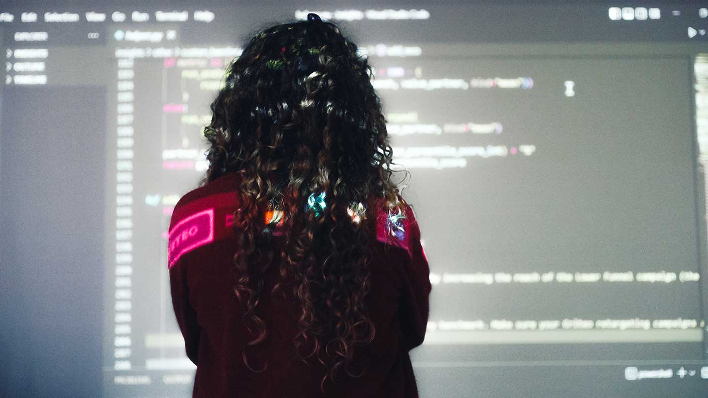 a woman looking at a screen