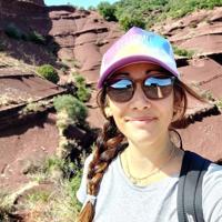 a woman taking a selfie in a rocky area