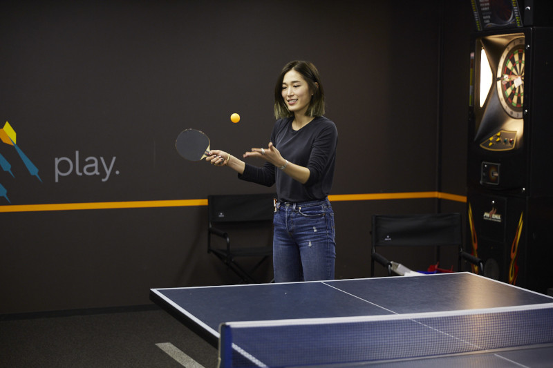 a woman playing ping pong