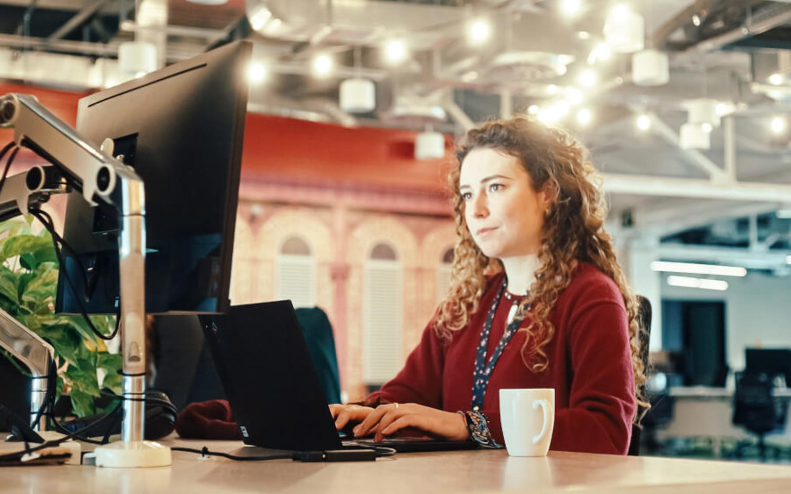 a woman sitting at a desk with a laptop