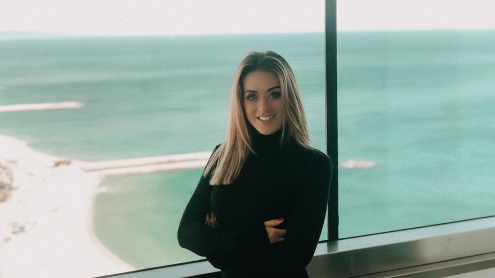 a woman standing in front of a window