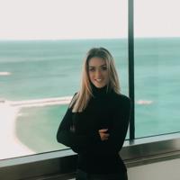 a woman standing in front of a window