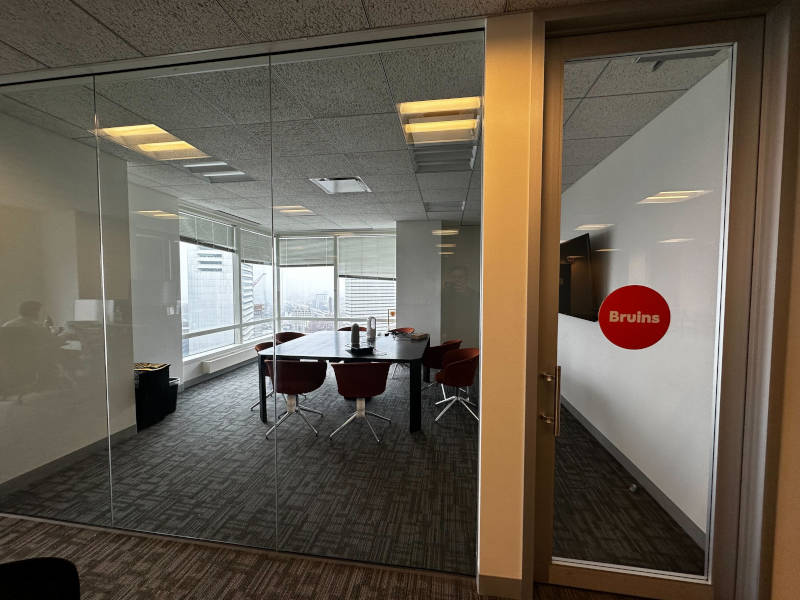 a glass door in a room with a table and chairs