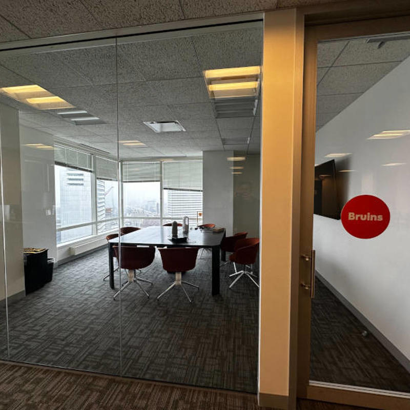 a glass door in a room with a table and chairs