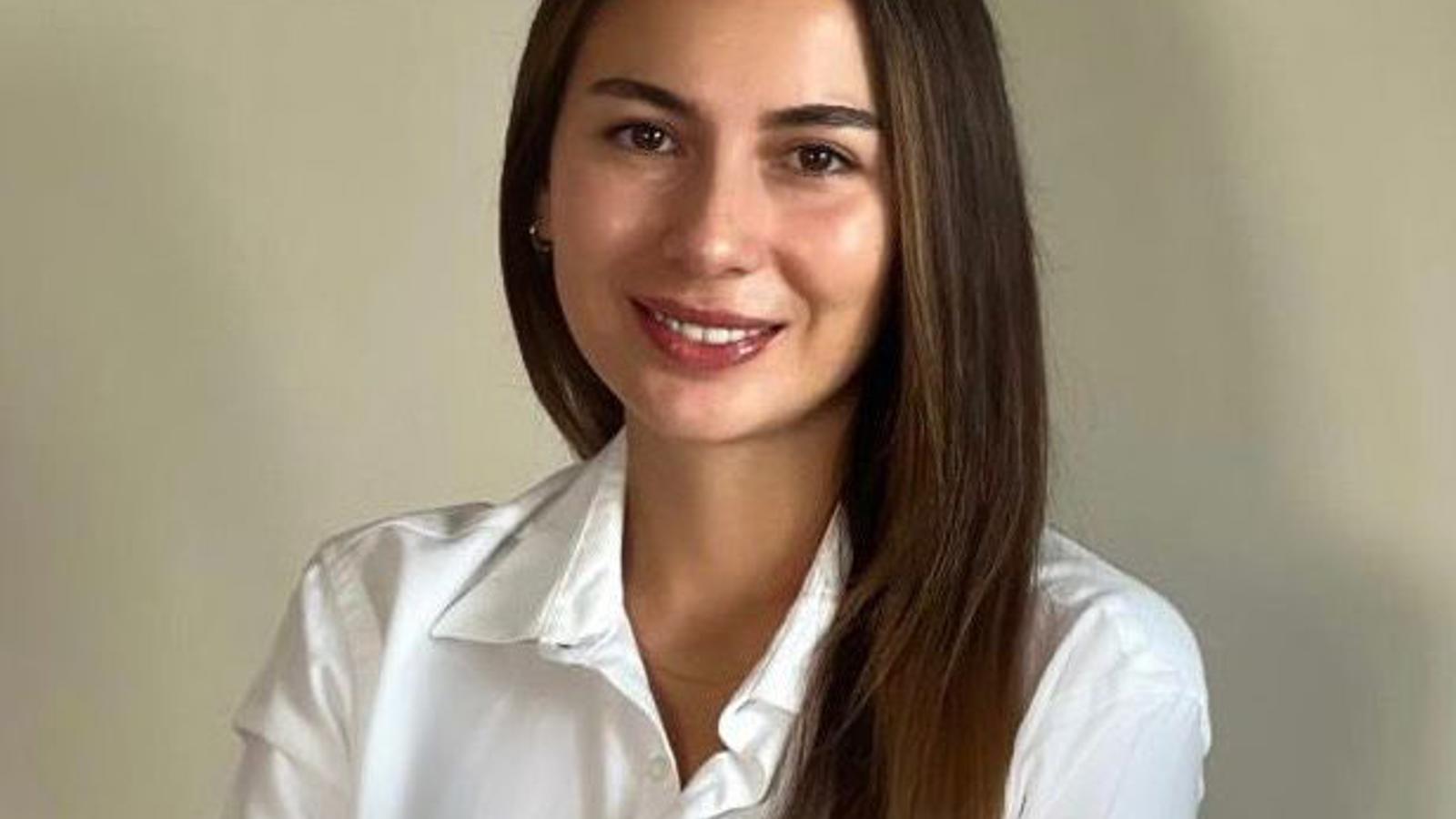 a woman with long hair wearing a white shirt