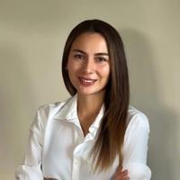 a woman with long hair wearing a white shirt