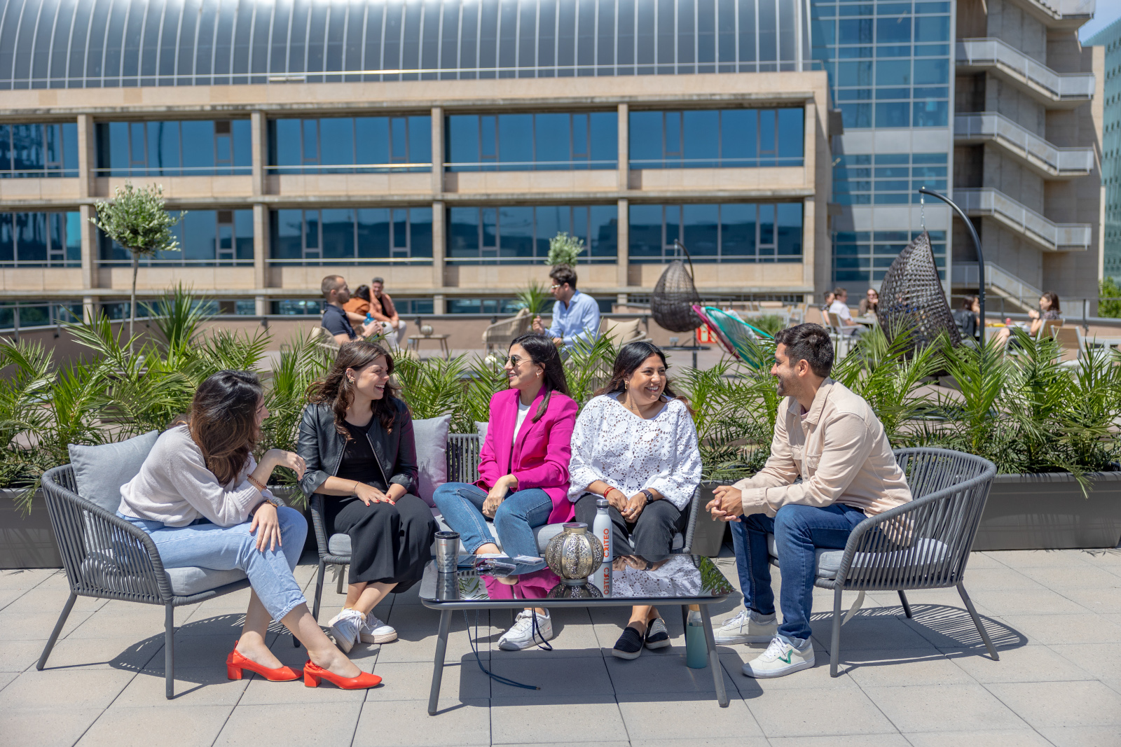 a group of people sitting on a bench outside