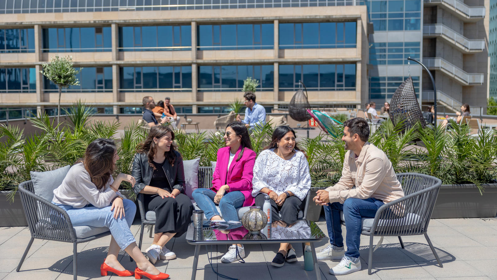 a group of people sitting on a bench outside