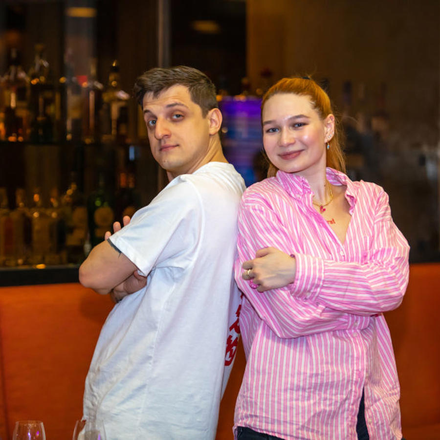 a man and woman standing back to back