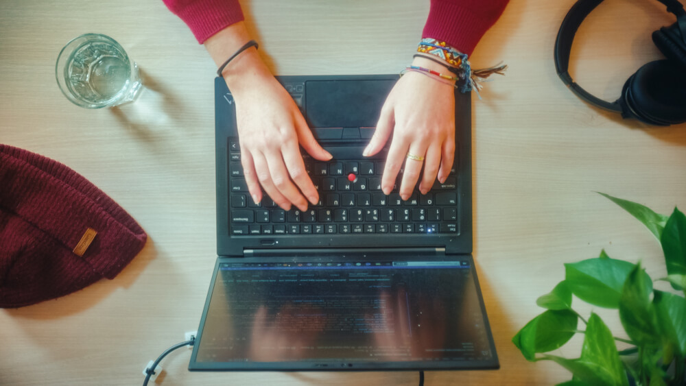 a person's hands on a laptop
